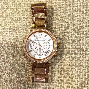Michael Kors watch rose gold with diamond bezel and white mother of pearl face.